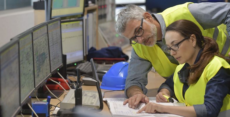 Two engineers working in front of computers