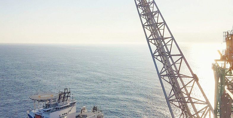 Cable laying vessel in front of platform Johan Sverdrup